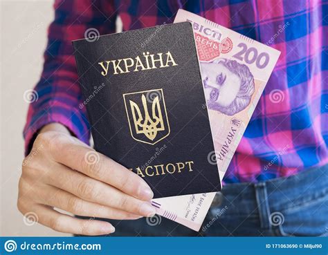 A Girl In A Shirt And Jeans Holds In Her Hand A Ukrainian Passport And