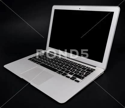 Photograph Laptop With Black Screen On The Dark Background 99651092