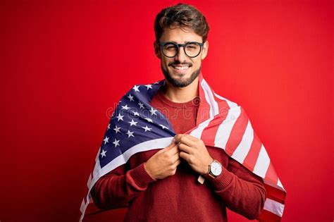 Young Man Wearing Glasses And United States Of America Flag Over