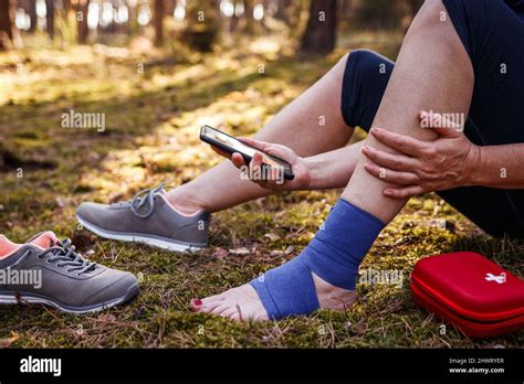 injured hiker  sprain ankle  smart phone    woman