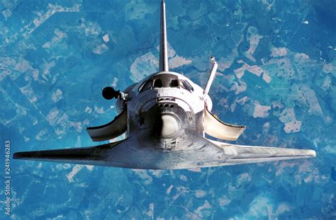 Spaceship on the flight. Space shuttle close-up. Flying rocket. View of the planet Earth from ...