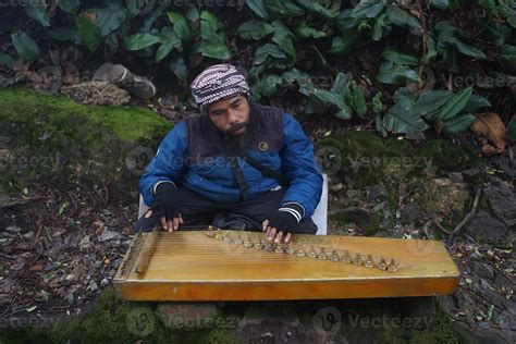 a man playing kecapi traditional Sundanese music in the Ciwidey ...