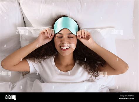 Happy African American Woman With Sleeping Mask In Bed Top View Stock