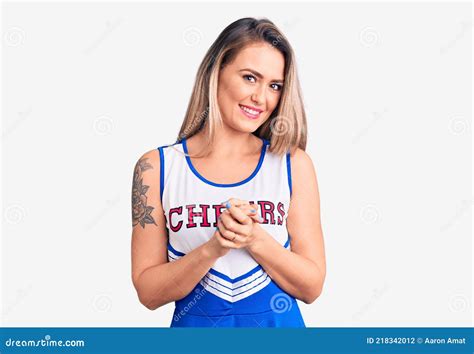 Young Beautiful Blonde Woman Wearing Cheerleader Uniform With Hands