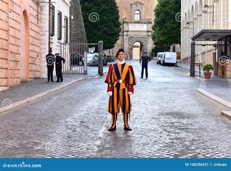 Pontifical Swiss Guard In His Traditional Uniform With Sunset Light At