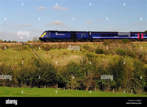 A First Great Western High Speed Train Passing A Footpath Crossing Over