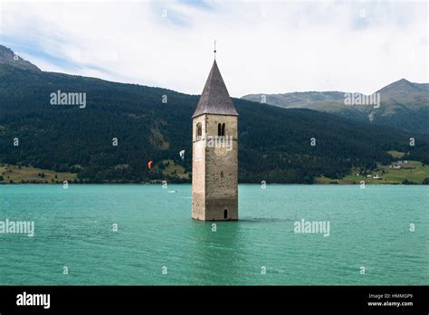 The old church tower of Reschen sticking out of the reservoir Lake Reschen, Italy Stock Photo ...