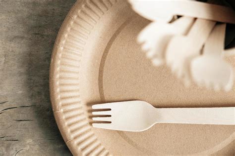 Wooden Forks And Paper Cups With Plates On Wooden Background