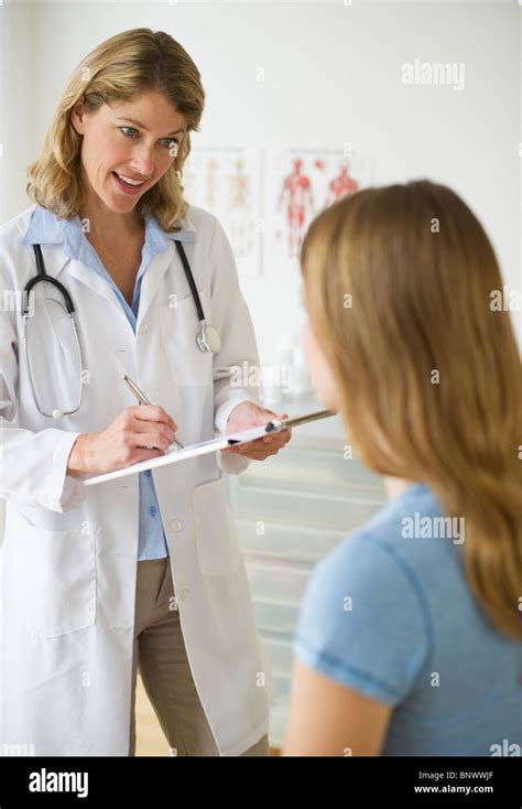 Doctor Talking To Patient In Exam Room Stock Photo Alamy