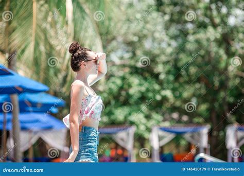 Beautiful Young Girl Relaxing Near The Swimming Pool Stock Image