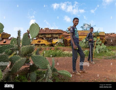 Eritrean boys in the military tank graveyard, Central region, Asmara, Eritrea Stock Photo - Alamy