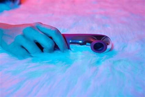 Premium Photo Desire Concept Woman Lying In Bed Holding A Dildo Vibrator In Her Hand To Help