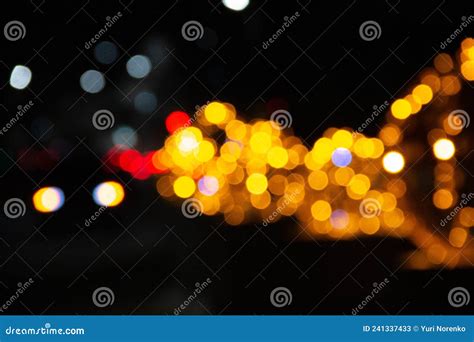 Bokeh Of Lights Of Garlands Lanterns And Car Headlights Stock Image