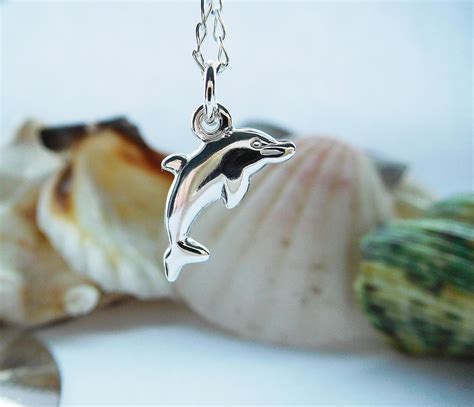 A Beautiful Sterling Silver Dolphin Charm On Your Choice Of Four