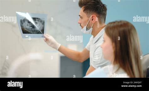 Dentist showing x-ray of a jaw for a young patient Stock Video Footage - Alamy