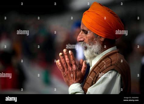 A Sikh Devotee Pays Obeisance As Devotees Unseen Carry A Gold Plated