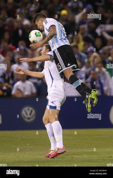 Argentina's Nicolas Otamendi (15) climbs the back of Bosnia-Herzegovina ...