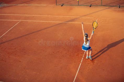 Woman Playing Tennis On Clay Court With Sporty Outfit And Healthy