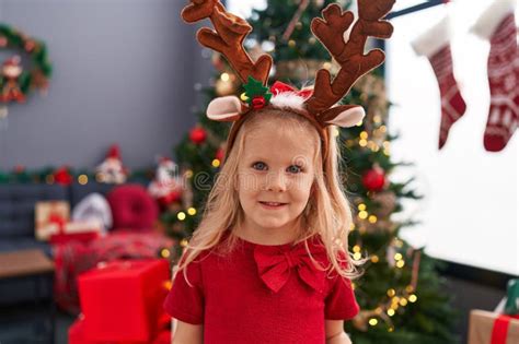Adorable Blonde Girl Smiling Confident Standing By Christmas Tree At Home Stock Image Image Of