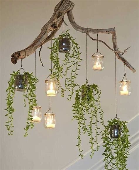 Several Mason Jars Filled With Plants Hanging From A Ceiling