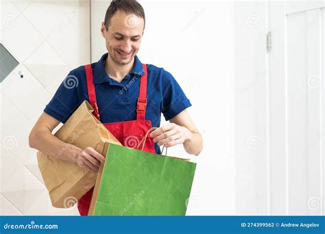 Two Boxes With Fast Food Being Carried By Delivery Man In Uniform For