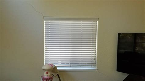 Why are cracks forming in my plaster and stucco near the windows