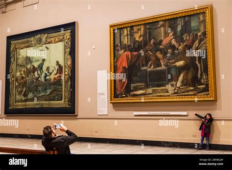 Interior view showing father photographing daughter in front of artwork ...