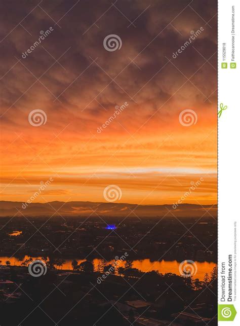 Dramatic Orange Sunset Over The Coastline And Buildings Of Surfers