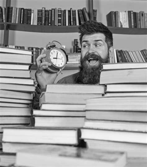 Man Scientist Peeking Out Of Books Teacher Or Student With Beard