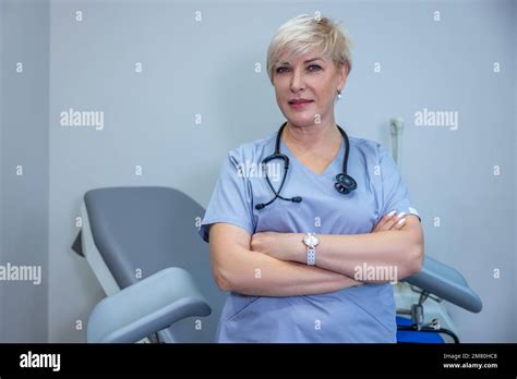 Short-haired blonde female doctor in bluse scrubs Stock Photo - Alamy