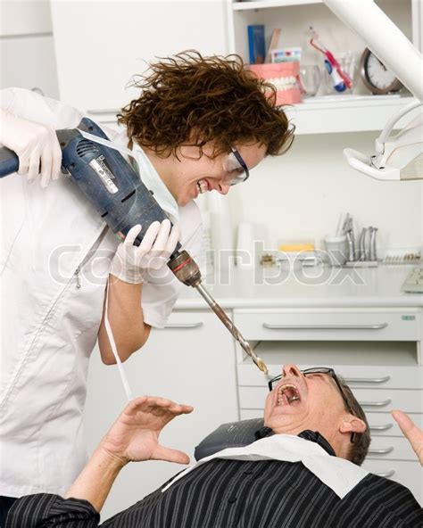 A Crazy Female Dentist With A Power Stock Photo Colourbox