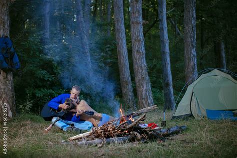 Стоковое фото Camping Sexy couple Passionate couple kissing boy and girl Having sex Young
