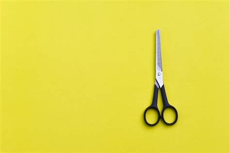 Premium Photo | Professional hairdressing scissors on yellow background