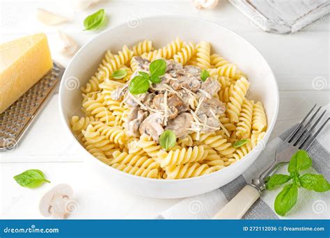 Fusilli Pasta With Mushrooms Cheese And Fresh Basil In A Plate On A