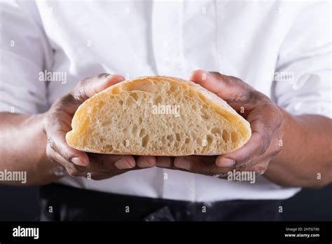 Close Up Midsection Of African American Male Baker Showing Cross