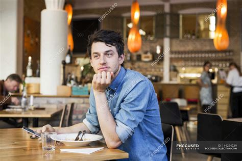 Man Sitting At Restaurant — Mid Adult Telecommunications Equipment