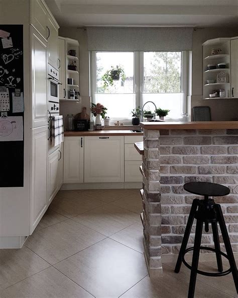 Modern White Kitchen With Brick Island