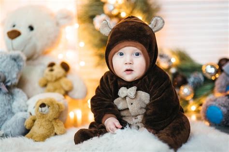 Premium Photo | A small child in a brown teddy bear costume sits on the ...