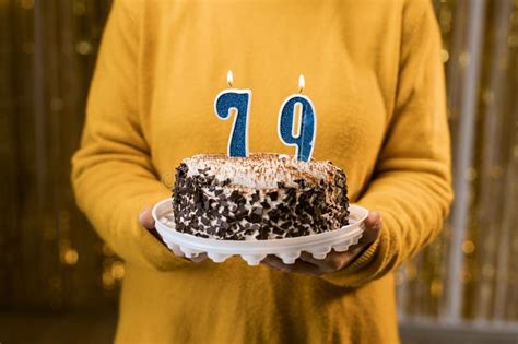 Woman Holding A Festive Cake With Number 79 Candles While Celebrating Birthday Party Birthday