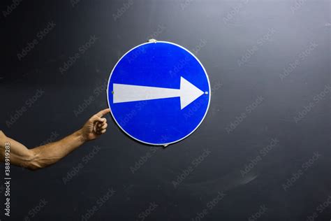 The Hand Points To The Blue Sign With Arrow Round Blue Sign With Arrow