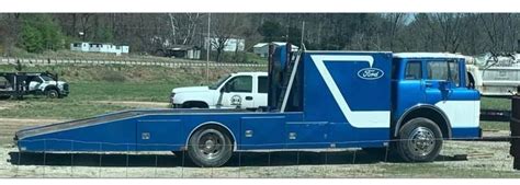 A Blue And White Semi Truck Parked In A Field