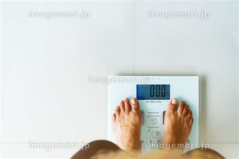 Old Woman Standing On Weight Scale White Color