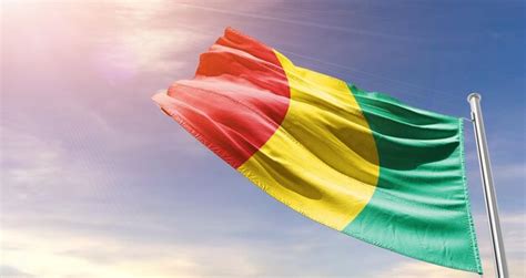 Premium Photo Guinea National Flag Waving In The Sky