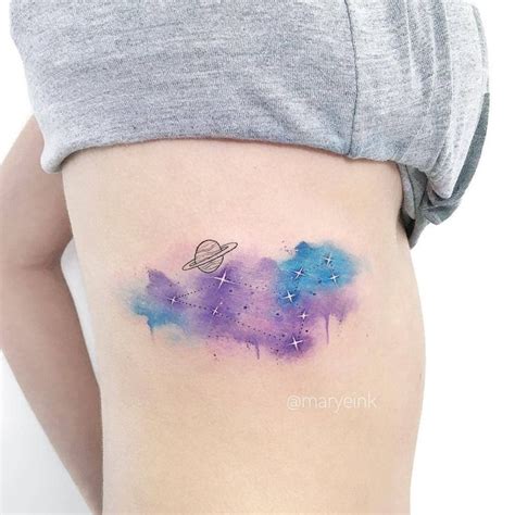 a woman's thigh with a watercolor tattoo on it