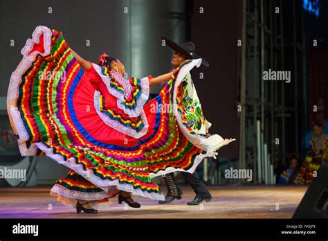 A traditional Mexican Jalisco dancer spreading her colorful red dress ...