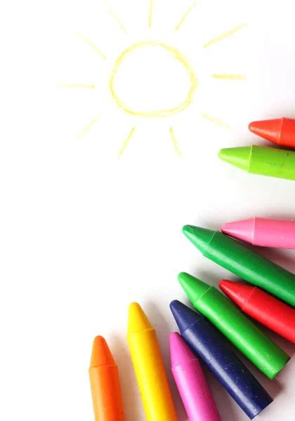 Oil Pastel Crayons Lying On A Paper With Painted Rainbow Stock Photo