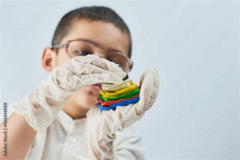 Little boy scientist in white making experiments against the white ...