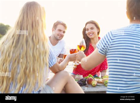 Friends on summer beach picnic Stock Photo - Alamy