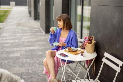 Premium Photo | Woman enjoys coffee at cafe outdoors