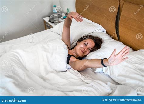 Woman Woke Up And Stretching In Bed In The Morning In Hotel Room Stock